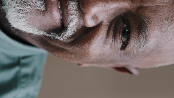 Extreme Close Up Half Face Vertical View Smiling Old Wrinkled Male with Gray Beard Bald African