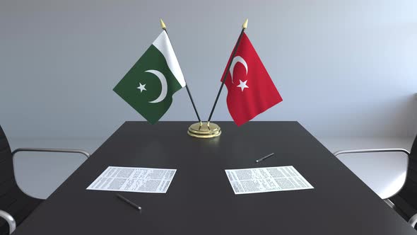 Flags of Pakistan and Turkey and Papers on the Table