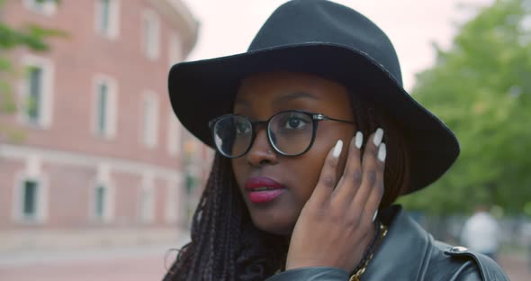 Young African American Woman Smiling Happy Listening to Music Using Earphones at City