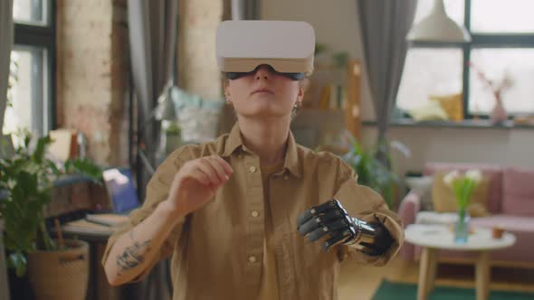 Woman with Prosthetic Arm Using VR Headset at Home