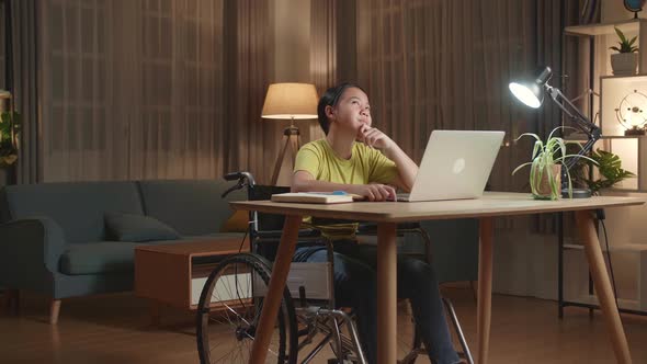 Asian Kid Girl Sitting Working On Laptop Computer And Thinking Then Raising Her Index Finger