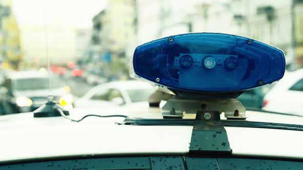 Flashing Flasher on the Roof of a Police Car. Blinker. Close-up.