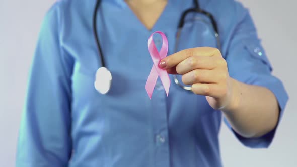 Female Doctor Holding Pink Ribbon, International Breast Cancer Awareness Symbol