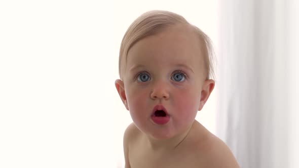 Portrait of a Surprised Baby with Big Blue Eyes