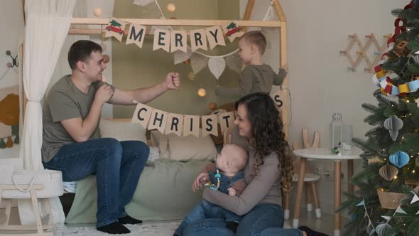 Young Family Preparing for Celebrating Christmas