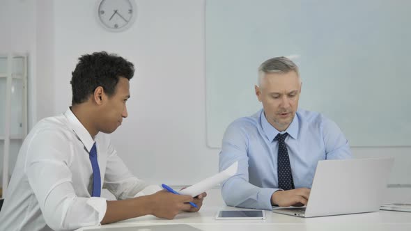 Multi Ethinic Businessmen Working Together on Business Project in Office