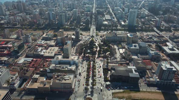 Aerial rising over Vergara Square, Libertad Avenue traffic and Viña del Mar buildings near the sea s