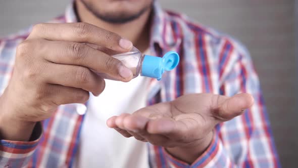 Young Man Using Sanitizer Liquid for Preventing Corona Virus