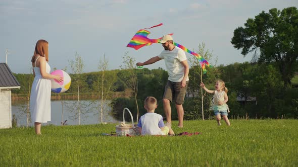 Happy Family Together and Have Fun in Nature Playing with Children with a Kite