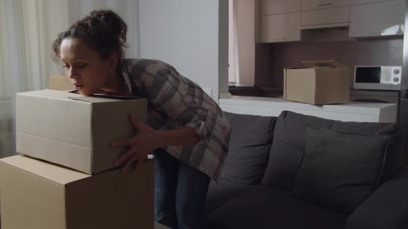 Adult Woman Carrying Cardboard Boxes While Moving to New Apartment