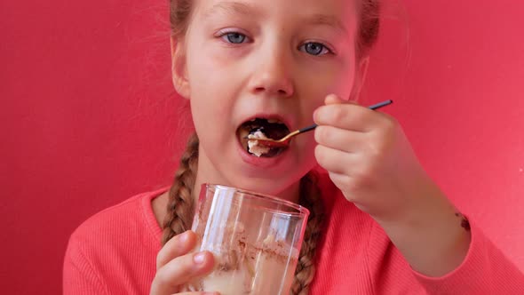 Child eating yogurt jelly pink background Dairy product diet Lactobacillus Acidophilus healthy food