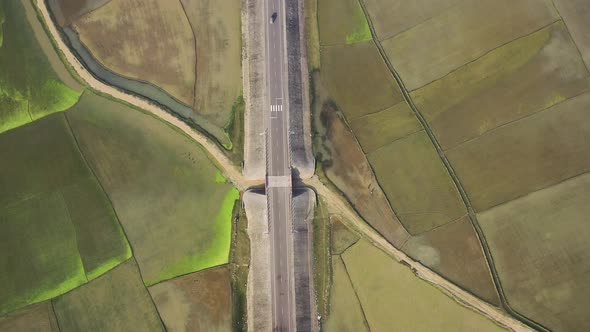 Aerial view of a road among the fields in Sapahar, Rajshahi, Bangladesh.