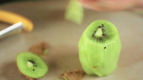 Peeling and slicing organi kiwi.