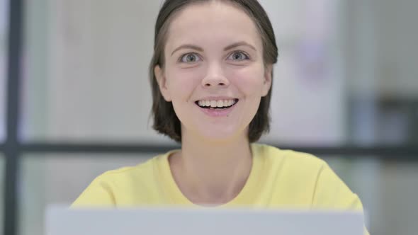 Close Up of Woman with Laptop Showing Thumbs Up