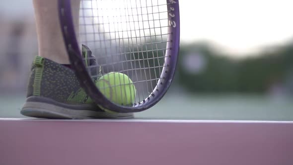 The Game of Tennis. In the Foreground Is a Tennis Racket and an Athlete's Foot in Sneakers. Racket