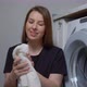 A Young Housewife Woman Takes Fresh Washed Clean White Towel and Smell - VideoHive Item for Sale