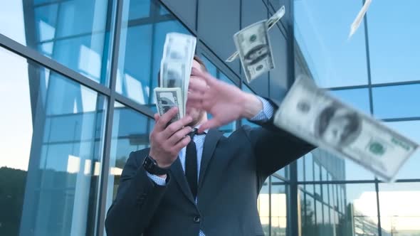 Crazy Business Man Throws Money in the Air He is Near the Office