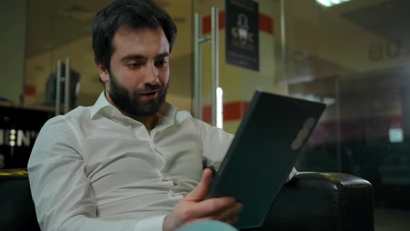 Caucasian Man Portrait with Tablet PC Inside Modern Barbershop