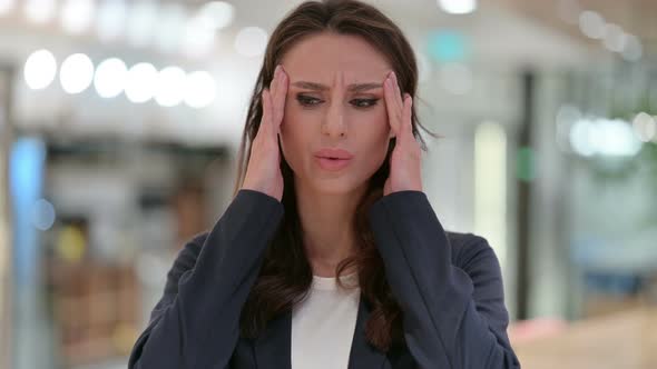 Portrait of Young Businesswoman Having Headache 