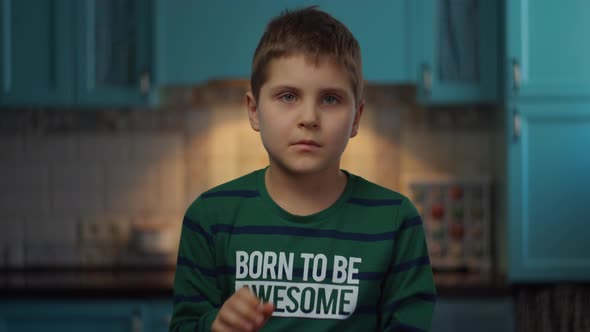 Portrait of autistic boy standing at home