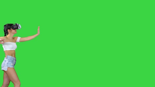 Woman Using VR Virtual Reality Headset Walking and Dancing on a Green Screen, Chroma Key