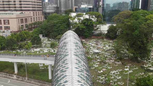 Drone flying backward from graveyard and passing through is the bridge