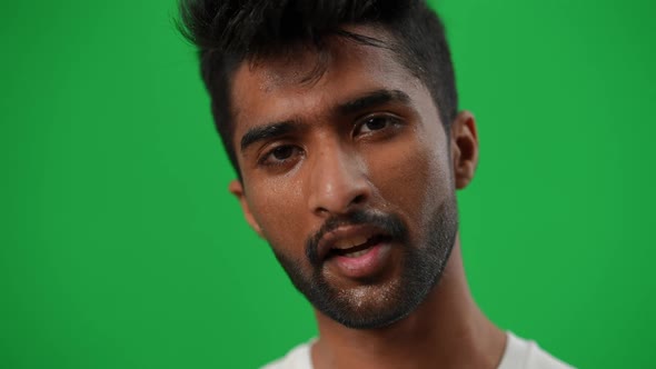 Closeup Exhausted Middle Eastern Perspiring Sportsman Looking at Camera Smiling Wiping Sweat Off