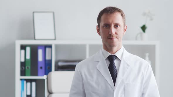 Professional medical doctor working in hospital office using computer technology.