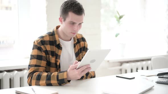 Upset Young Man Shocked By Loss on Tablet