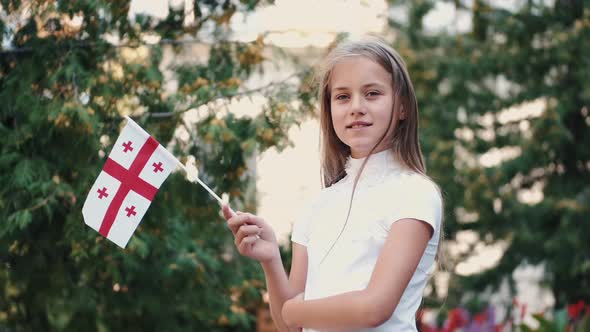 Little Girl Holding Georgian Flag Standing Outside