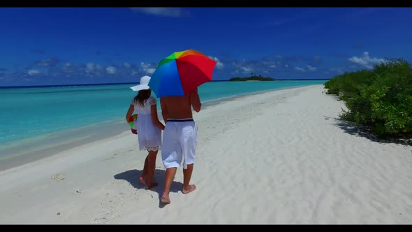 Guy and girl engaged on paradise shore beach wildlife by blue green water and white sand background 