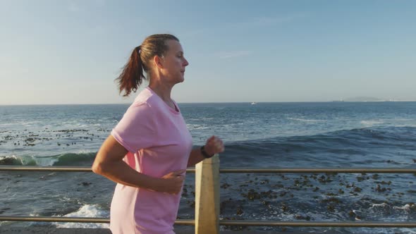 Senior woman running on a promenade