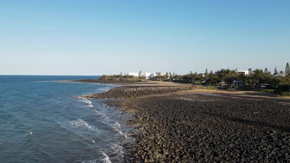 A fasting drone video showing the raw rocky coastline of the small town of Bargara located in the re