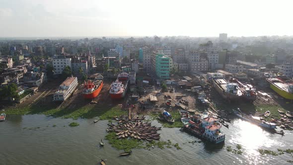 Aerial over wrecked shipyard choking banks of river canals and causing environmental degradation. Ba