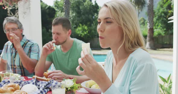 Happy family eating together at table