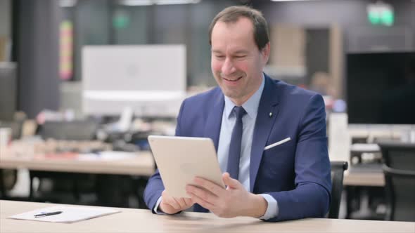 Businessman Making Video Call on Tablet in Office