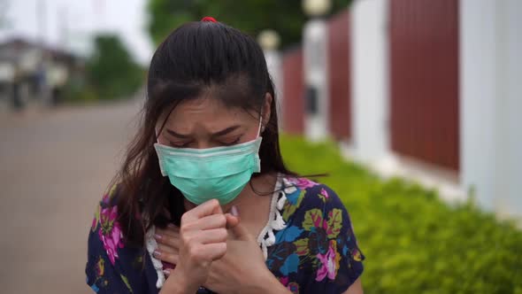 slow-motion of sick young woman wearing surgical mask (medical mask) is coughing, virus protection.