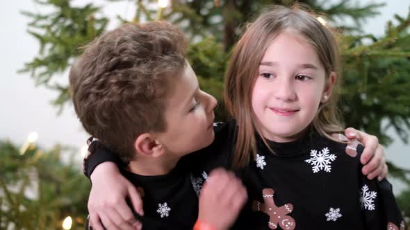 Little Brother Kisses His Sister on the Cheek