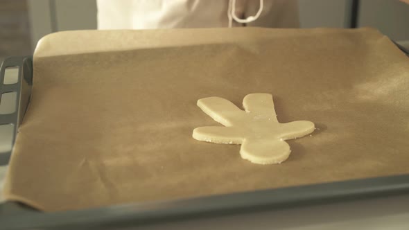 Closeup Putting Ginger Bread Family Dough on Baking Tray