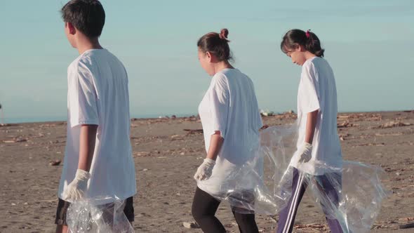 Asian Team Of Volunteers On Beach