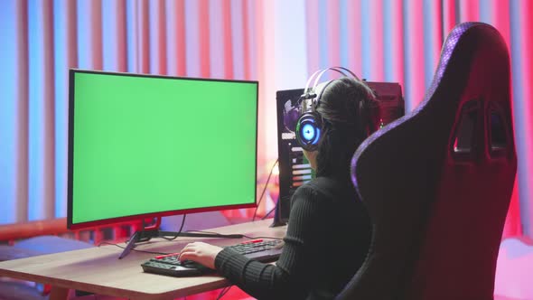 Young Girl Playing Exited Computer Game With Green Screen Display alt