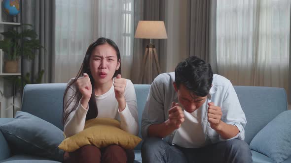 Upset Young Asian Couple Is Frustrated About The Loss Of The Team In Game They Are Watching Tv