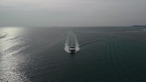 Aerial Drone Footage of Sailing boat passing from the horizon to the top view