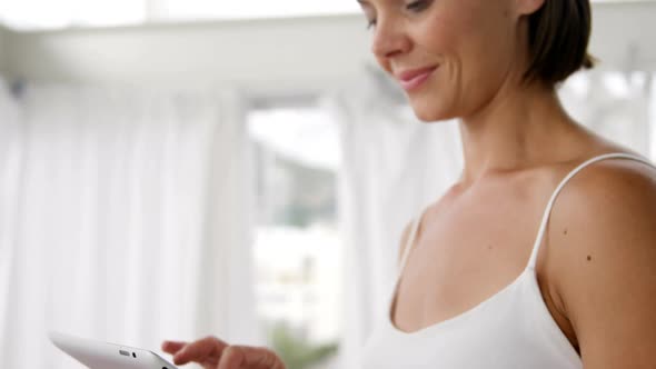 Smiling woman using her tablet