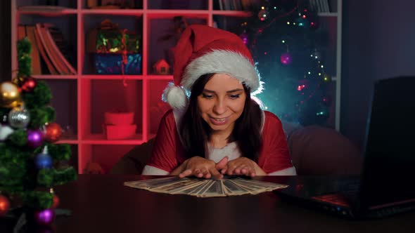 Young Woman in Santa Costume with Dollar Bills in Office