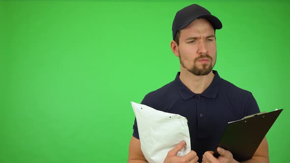 A Young Handsome Mailman Thinks About Something - Green Screen Studio