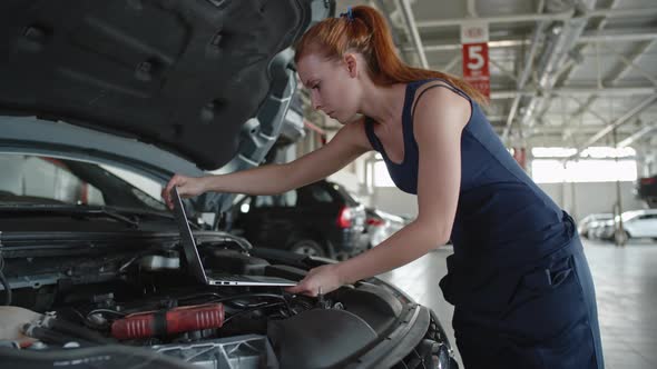 Woman Testing Car with Laptop alt
