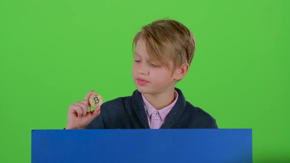 Teenager Boy Gets Up From Behind the Board with the Chip on a Green Screen