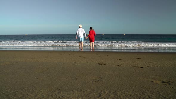 Couple in Love Carefree Running to the Water on the Beach