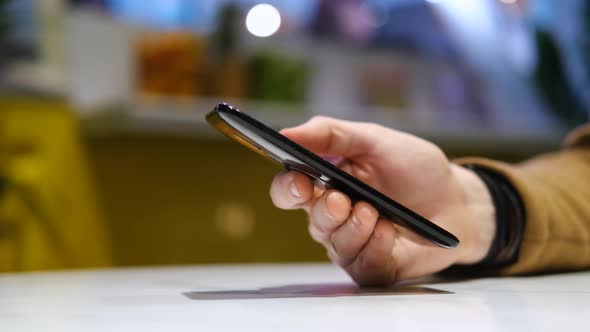 close-up male hand with smartphone